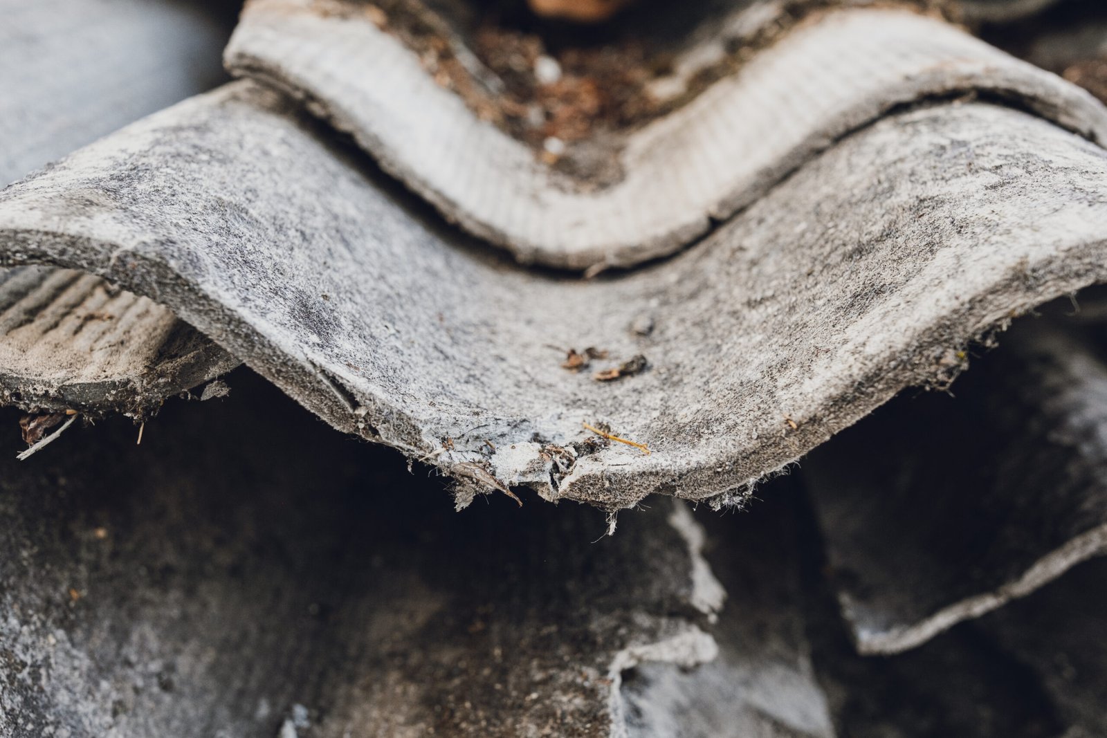 Old and very dangerous asbestos roof. Asbestos dust in the environment. Health problems.